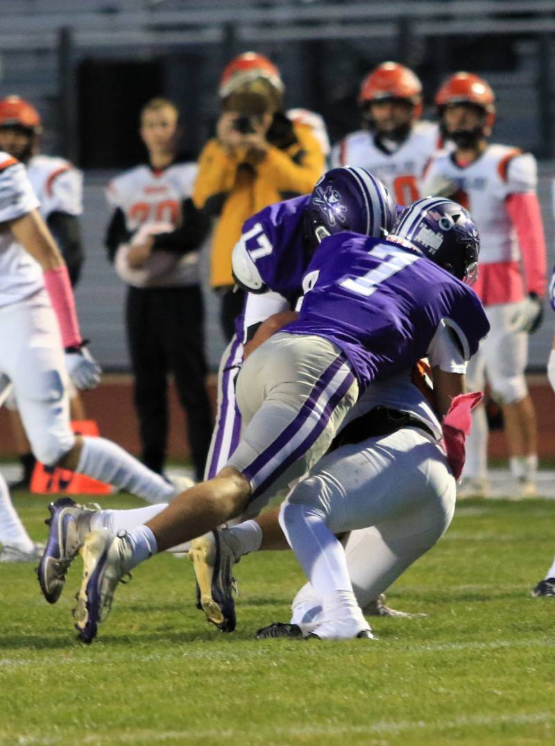 Rochelle's Mark Green (7) and Reece Harris (17) tackle a Waterloo player during their game Friday, Oct. 24, 2025 in Rochelle.