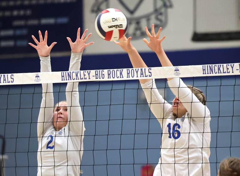 Hinckley-Big Rock's Anna Herrmann (left) and Grace Barrett try to block an Indian Creek spike during their match Tuesday, Sept. 24, 2024, at Hinckley-Big Rock High School.