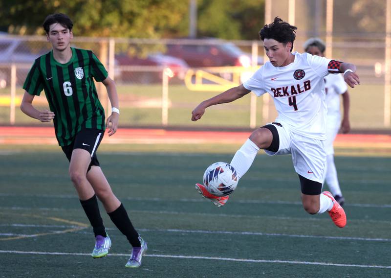 DeKalb's Zachariah Murray makes a jumping play in front of St. Edward's Drew Kapetan Thursday, Aug. 28, 2025, during their game in the Barb Cup tournament at DeKalb High School.
