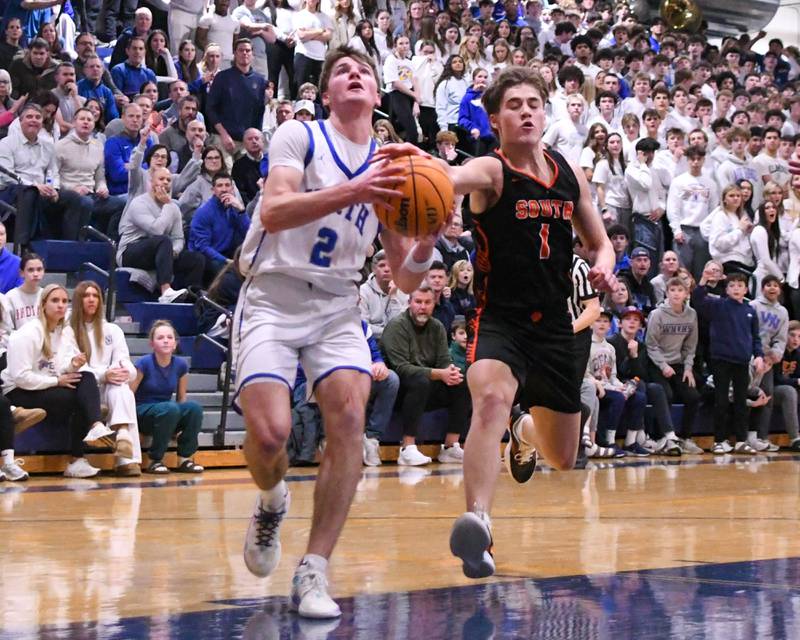Wheaton North's Briggs Barnick (2) gets his shot blocked by Wheaton Warrenville South's Brady McClatchy (1) during the game on Friday Feb. 6, 2026, held at Wheaton North High School.