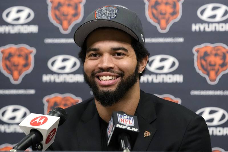 Chicago Bears No. 1 draft pick quarterback Caleb Williams smiles as he listens to reporters during an NFL football news conference in Lake Forest, Ill., Friday, April 26, 2024.