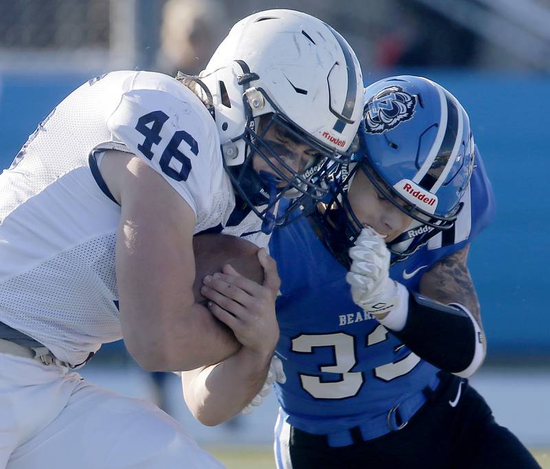 Cary-Grove's Logan Abrams runs through the tackle attempts of Lake Zurich's Bryce Erkman to score a touchdown during a IHSA Class 6A semifinal playoff football game on Saturday, Nov. 18, 2023, at Lake Zurich High School.