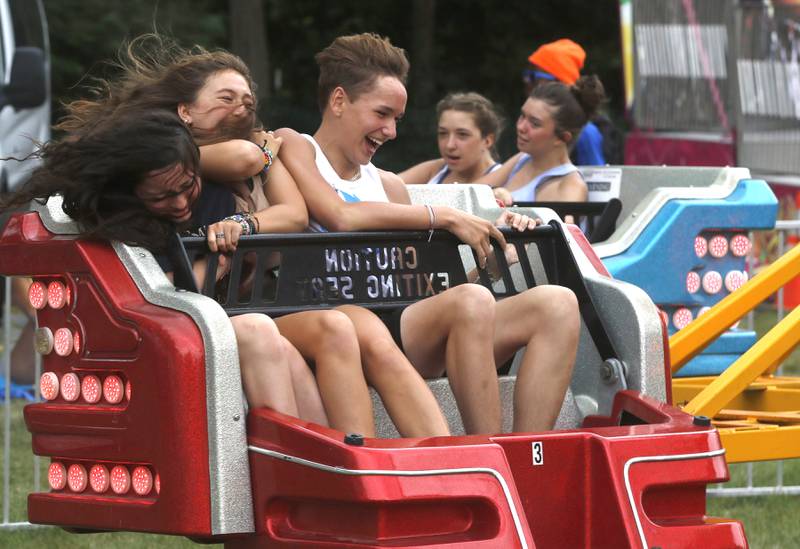 Lilly Clausen, 14, Maya Cook, 14, and Will Bajak, 14, all of Crystal Lake, ride on the Sizzler during Lakeside Festival on Friday, July 1, 2022, at the Dole and Lakeside Arts Park, 401 Country Club Road in Crystal Lake. The festival continues from noon to 11 p.m. July 2 and noon to 10 p.m. July 3. The festival features bands on two outdoor stages, food and drinks, a baggo tournament, and carnival rides and games. Among the activities for kids are face painting, a balloon twister, a stilt walker, team mascots and a magician.