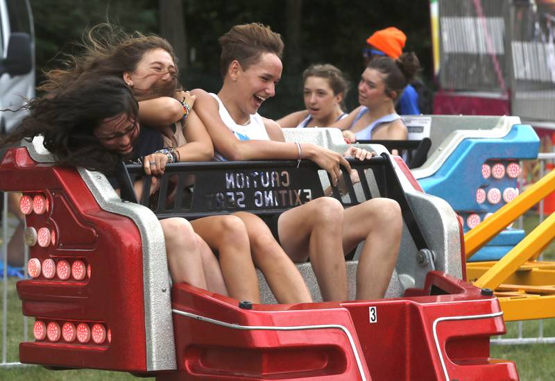 Lilly Clausen, 14, Maya Cook, 14, and Will Bajak, 14, all of Crystal Lake, ride on the Sizzler during Lakeside Festival on Friday, July 1, 2022, at the Dole and Lakeside Arts Park, 401 Country Club Road in Crystal Lake.