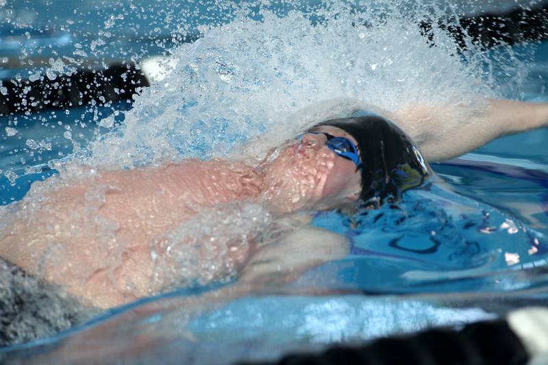 Lyons Township’s Quinn Collins competes in the championship heat of the 100-yard backstroke during the IHSA Boys Swimming and Diving Championships at FMC Natatorium in Westmont on Saturday, Feb. 26. 2022.