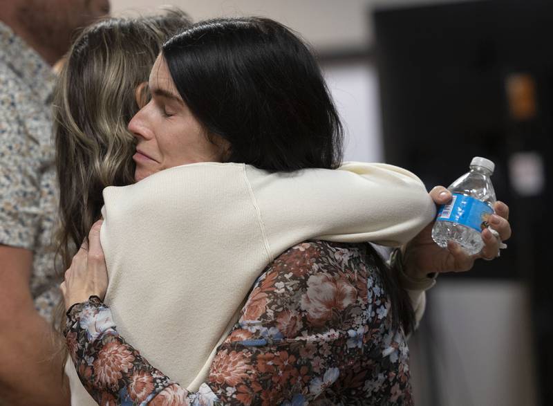 Brittany Ramos is hugged by supporters Friday, Nov. 14, 2025, after a jury awarded her $31.5 million dollars for the wrongful death of husband firefighter Garrett Ramos.