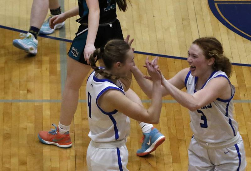 Woodstock's Keira Bogott celebrates with her teammate, Lily Novelle, after Woodstock defeated Woodstock North in a Kishwaukee River Conference basketball game on Friday, Jan. 10, 2025, at Woodstock High School.