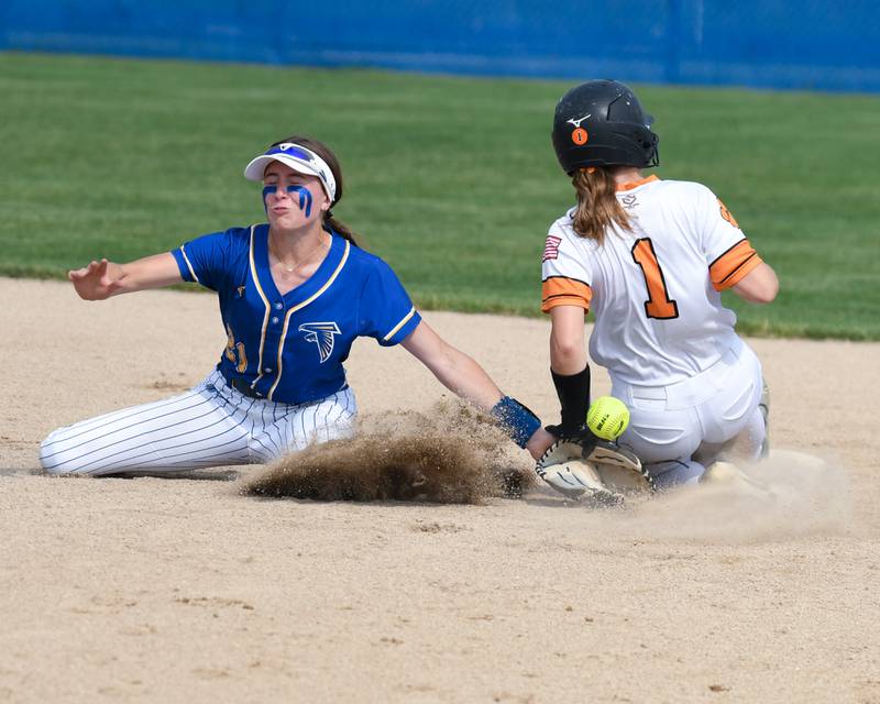 Wheaton North's Reagan Crosthwaite, left, tries to tag out Wheaton Warrenville South's Caroline Schulz (1) after stealing the base but came up short with the ball during the sectional semifinal game on Thursday June 5, 2025, held at Oswego High School.