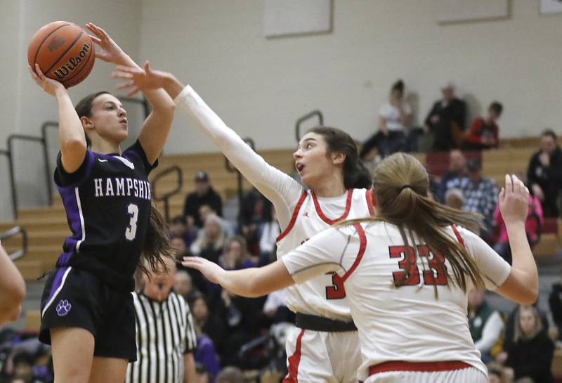Hampshire's Ceili Ramirez shoots the ball over Huntley's Cassidy Serpe and Mallory Winters during a Fox Valley Conference girls basketball game Monday, Jan. 30, 2023, at Huntley High School.