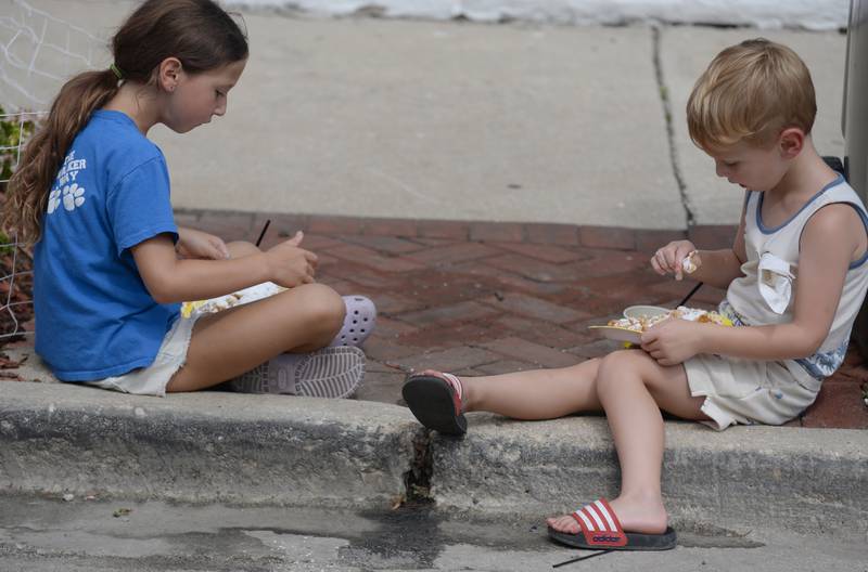 Avery and Jack Rademacher of Clarendon Hills enjoy funnel cakes during the Taste of Westmont Saturday July 12, 2025.