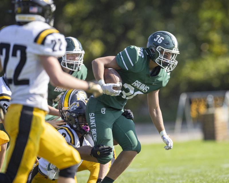 Landon Marquez of St. Bede fights for ever last yard as he attempts to break a Elmwood Park Tigers tackle during the homecoming game on September 30, 2023.