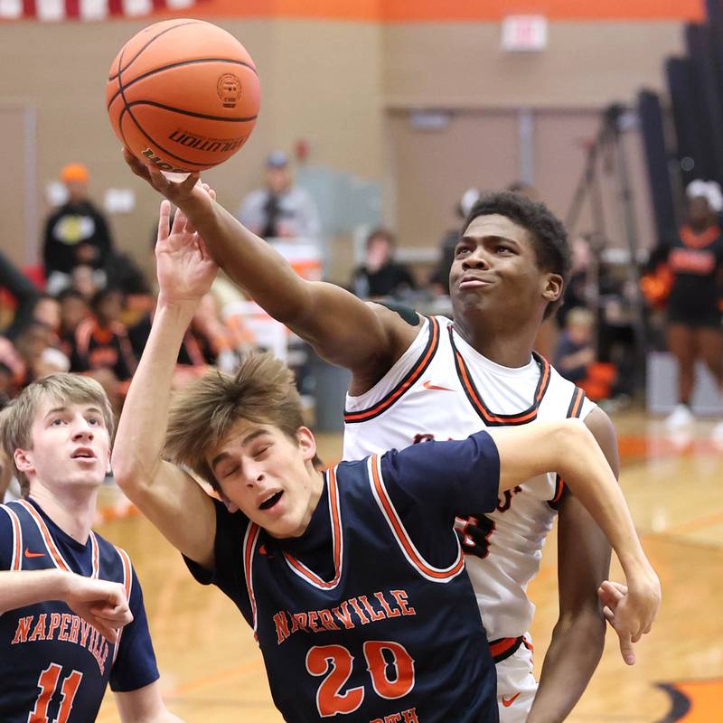 DeKalb’s Davon Grant grabs a rebound over Naperville North's Grant Montanari during their game Friday, Dec. 8, 2023, at DeKalb High School.