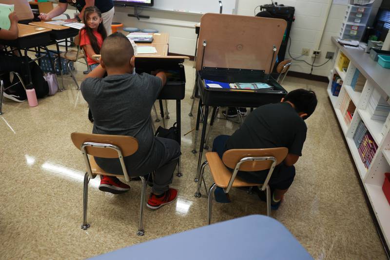 Students put away schools supplies in their desk on the first day of school at Woodland Elementary School in Joliet. Wednesday, Aug. 17, 2022, in Joliet.