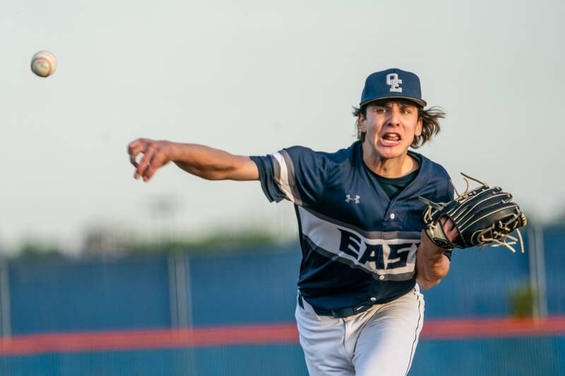 Oswego East's Griffin Sleyko (21) delivers a pitch against Oswego during a baseball game at Oswego High School on Tuesday, May 9, 2023.