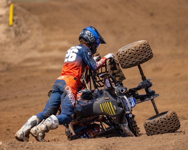 Pro ATVMX rider Brandon Hoag works to turn his flipped quad back upright during the ATVMX Championship race on May 24, 2025 at Sunset Ridge MX in Walnut.