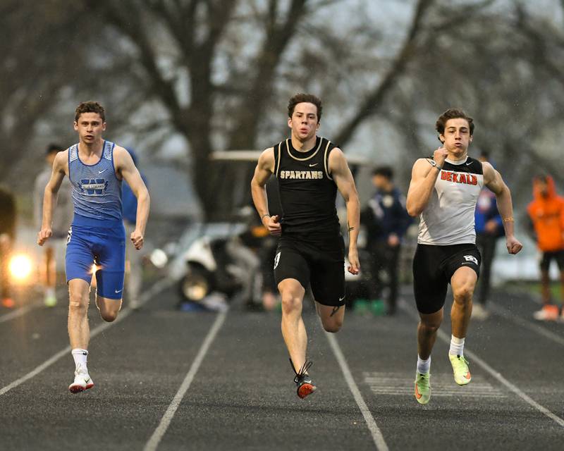 DeKalb Ethan Tierney, right, Sycamore Jeffery Oestreicher, center, and Woodstock Tim Maidment all compete in the the 100 meter dash Friday April 29th during the Gib Seegers Classic track and field meet held at Sycamore high school.