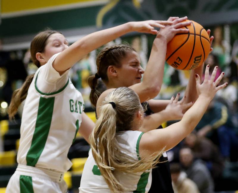 Crystal Lake South's Gaby Dzik (left) and Addison Schwab (right) trie to keep Prairie Ridge's Kylie Carroll from driving to the basket during a Fox Valley Conference girls basketball game on Friday, Dec. 13, 2024, at Crystal Lake South High School.