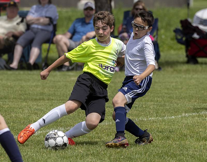 Sterling United’s Aticus Rippy (right) fights for the ball Sunday, May 19, 2024 at Scheid Park in Sterling.