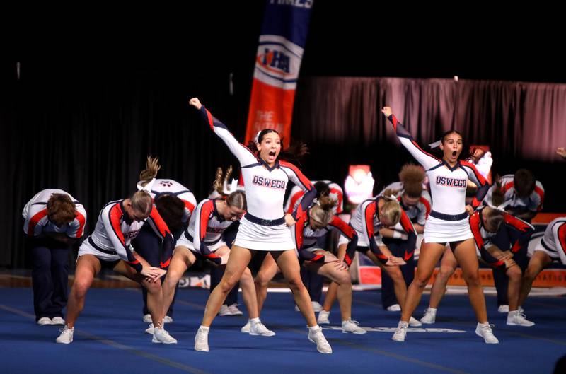 Members of the Oswego cheerleading team compete in the coed team division of the IHSA State Finals on Saturday, Feb. 8, 2025 at Grossinger Motors Arena in Bloomington.