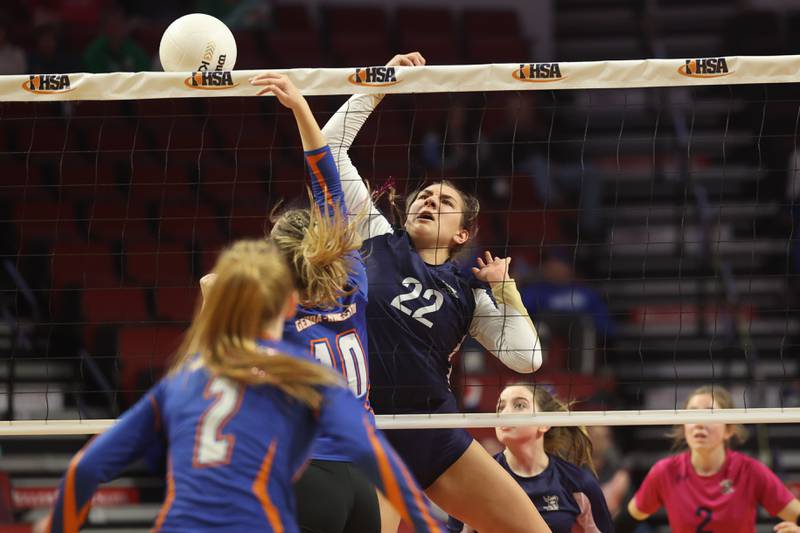 IC Catholic’s Jenny Fromelt battles for the ball at the net against Genoa-Kingston in the Class 2A championship match on Saturday in Normal.