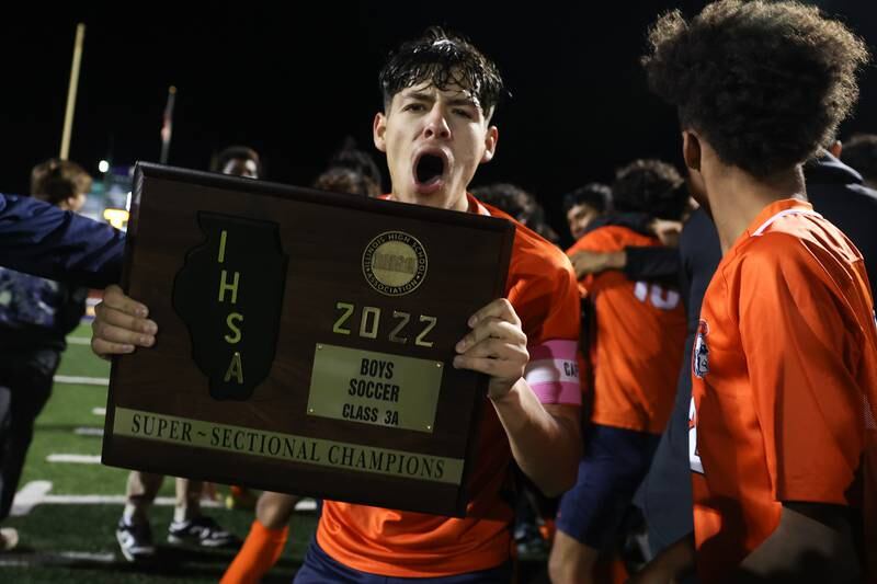 Romeoville’s Joseph Duarte celebrates with the championship plaque after their 4-1 win over Edwardsville in the Class 3A Bloomington Super-Sectional on Tuesday.