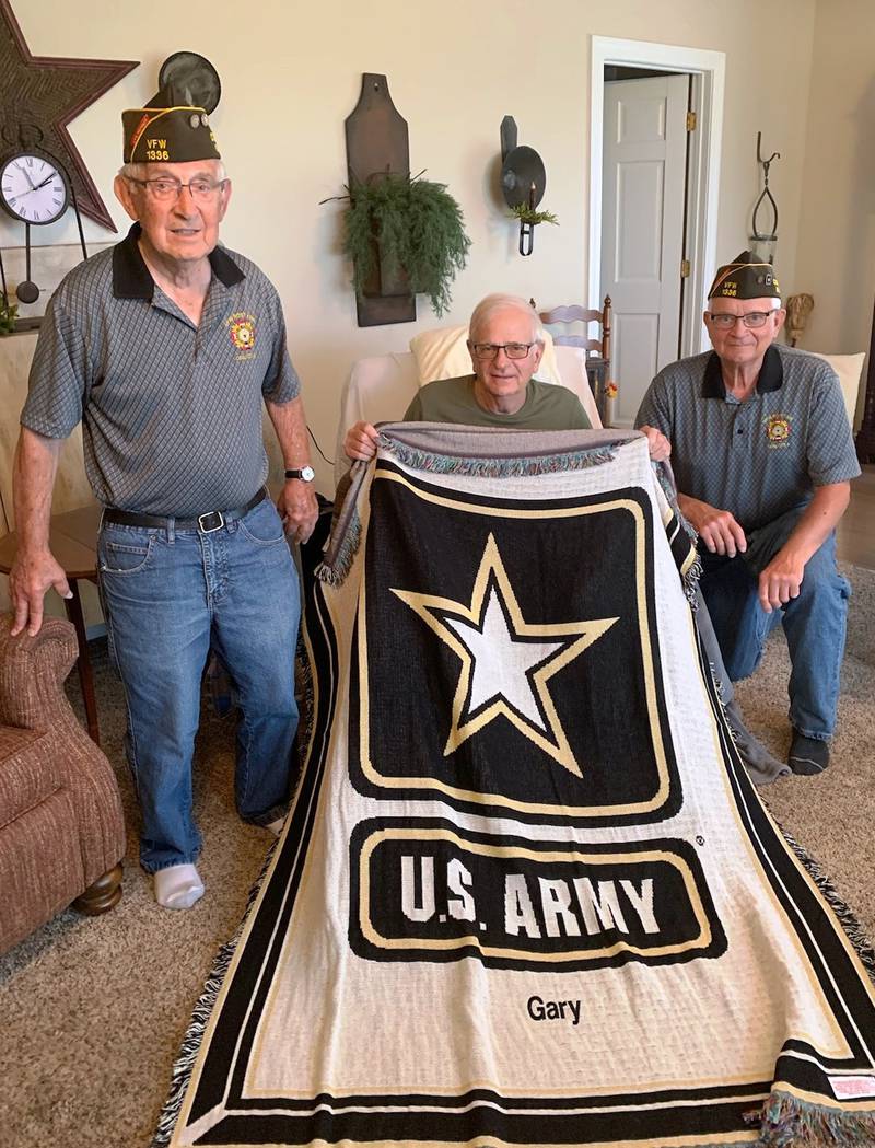 St. Juvin Post 1336 Trustees Pete Dolan (left) and Don Tira present Vietnam veteran Gary Skubic (center) with his throw.
