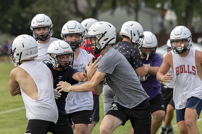 Players run through drills Monday, Aug. 12, 2024 during first day football practice for Dixon High School.