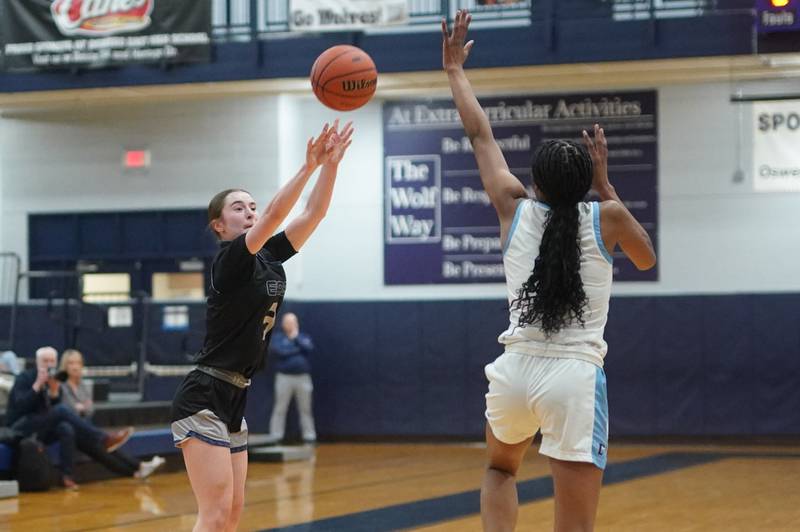 Oswego East's Maggie Lewandowski (3) shoots a three pointer against Downers Grove South's Hayven Harden (4) during a 4A Oswego East Regional semifinal girls basketball game at Oswego East High School on Monday, Feb 12, 2024.