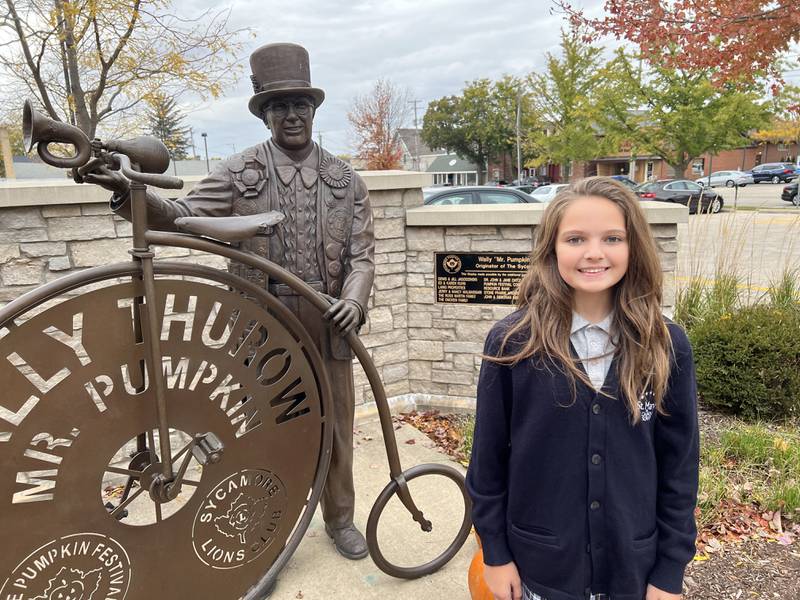 Vivian Rubicz stands by a statue of Willy Thurow on Oct. 13 2022.