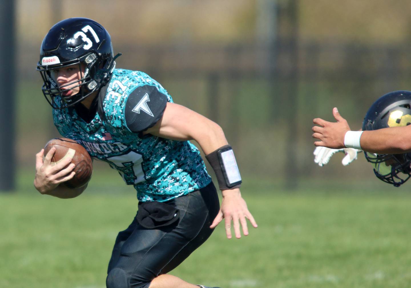 Woodstock North’s Kaden Combs runs the ball against Sycamore in varsity football in Woodstock Saturday.
