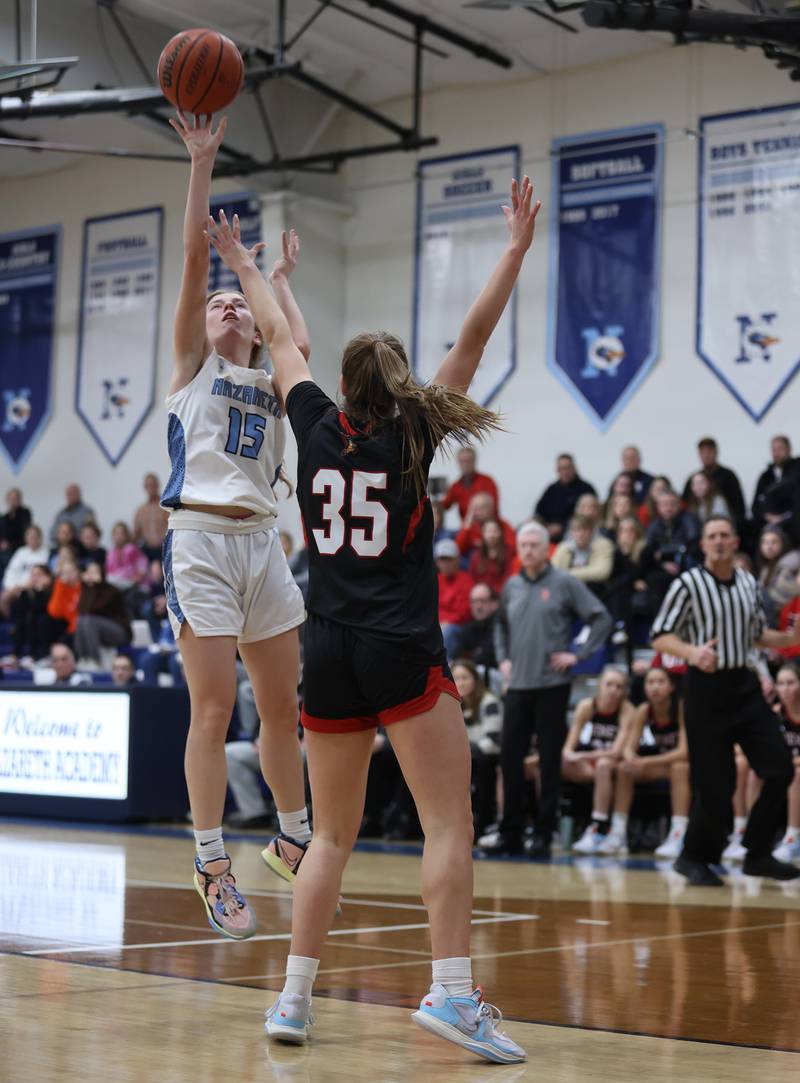 Nazareth's Mary Bridget Wilson (15) takes a shot during the girls varsity basketball game between Benet and Nazareth academies on Wednesday, Jan. 3, 2023 in La Grange Park, IL.