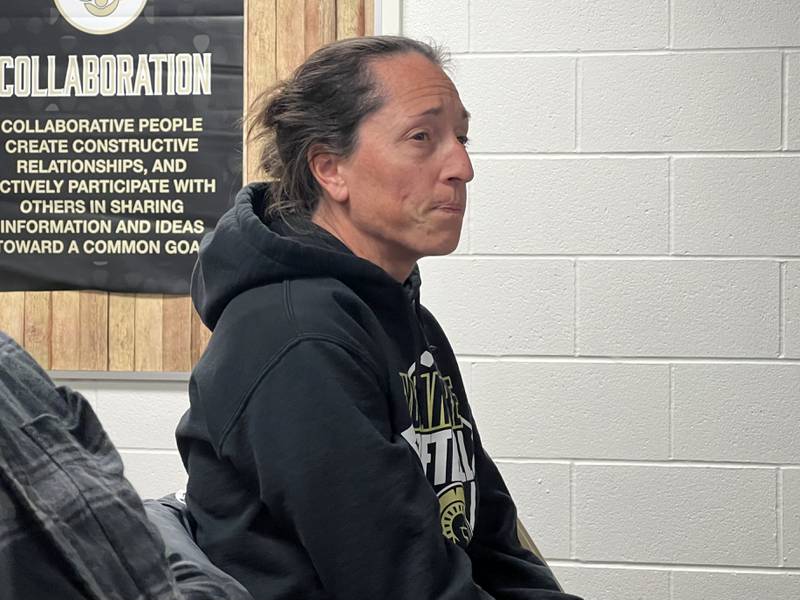 Head Coach of the Sycamore High School Softball Team, Jill Carpenter sits in the audience during the Sycamore Community School District Board of Education meeting on Nov. 15, 2022.