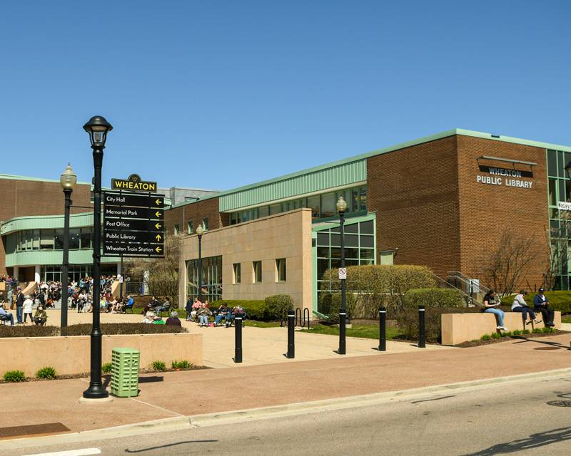 Community members gather around the Wheaton library on Monday April 8, 2024, for the solar eclipse watch party.