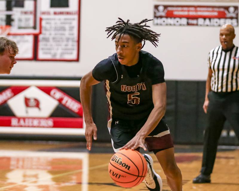 Plainfield North's Darin Ashiru (5) takes off to the basket during their basketball game between Plainfield North at Bolingbrook, Friday Dec 13, 2024 in Bolingbrook.