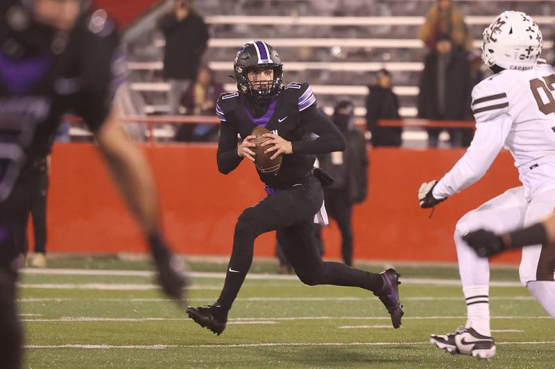 Downers Grove North’s Owen Lansu rolls out to pass against Mt. Carmel in the Class 7A championship on Saturday, Nov. 25, 2023 at Hancock Stadium in Normal.