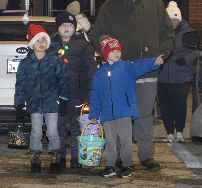 Children line up along the parade route and point out their favorites coming their way Saturday during the annual Holiday Magic Lighted Santa Parade in Marseilles.