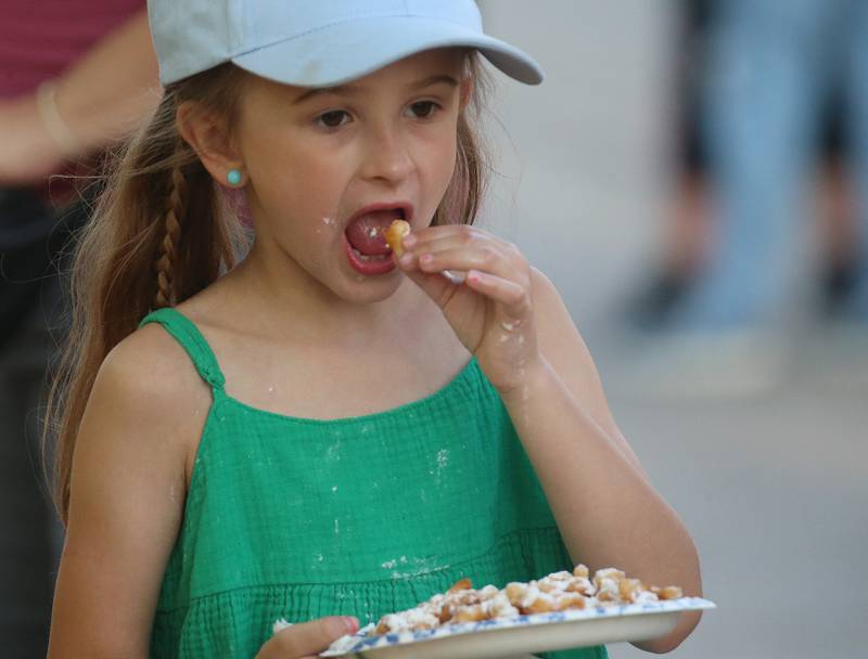Taylee Prater of Hennepin munches on a funnel cake during Spring Valley Summerfest on Thursday, June 19, 2025 downtown Spring Valley. The festival features a carnival, live entertainment, food vendors and fireworks on Saturday at dusk.
