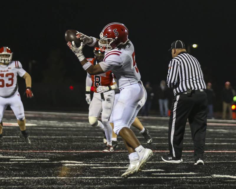 Yorkville's T.J. Harland (5) makes a catch across the middle and takes it into the endzone during football game between Yorkville at Bolingbrook Friday, Oct 24, 2025 in Bolingbrook.