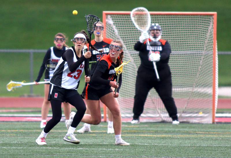 Huntley’s Allie Ambrogio, left, battles Crystal Lake Central’s Fiona Lemke in varsity lacrosse at Huntley Wednesday.
