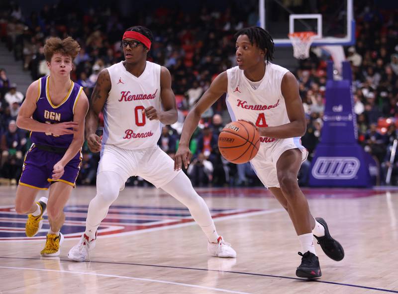 Kenwood Academy's Darrin James (4) brings the ball up against Downers Grove North during the boys 4A super-sectional game between Kenwood Academy and Downers Grove North high school in Chicago on Monday, March 6, 2023.