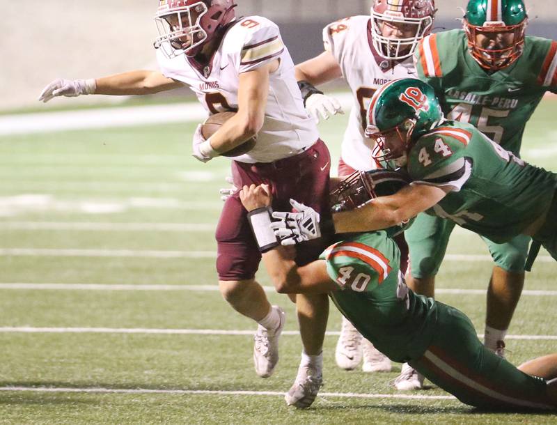 Morris's Caeden Curran tries to break free of L-P defenders Nick Hachenberger and Caeden Small on Friday, Sept. 20, 2024 at Howard Fellows Stadium.