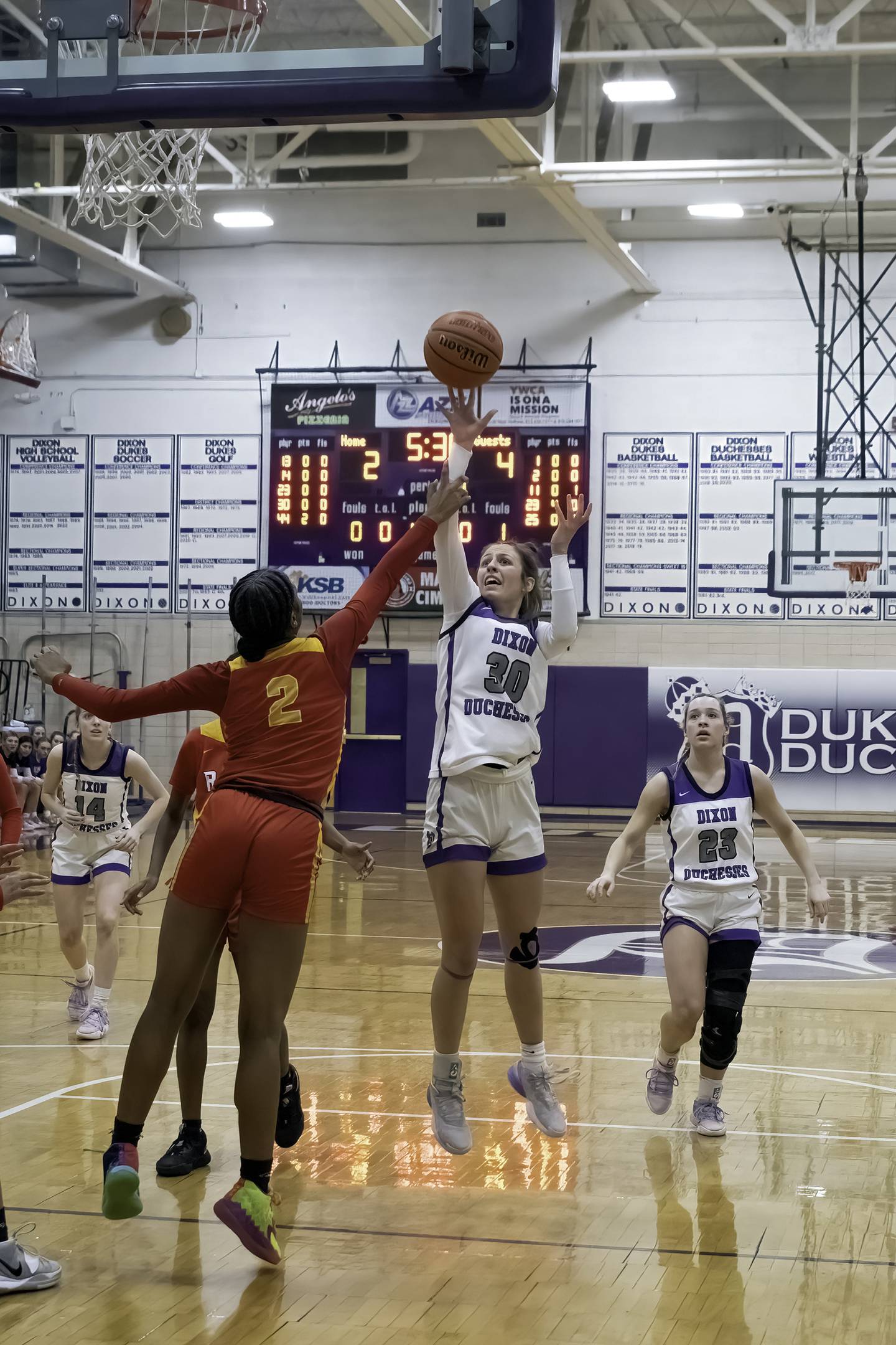 Dixon's Harvest Day (30) shoots over Rock Island's Ka'Zaria Bell during their Class 3A Dixon Regional semifinal Tuesday, Feb. 14, 2023 at Lancaster Gym.