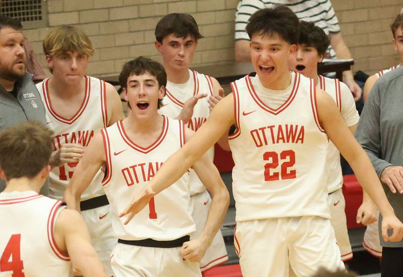 Ottawa players Colt Bryson and Dom Parks react as teammate Blake Schiltz makes a basket against Princeton during the Dean Riley Shootin' The Rock Thanksgiving Tournament on Monday Nov. 24, 2025 in Kingman Gymnasium at Ottawa High School.