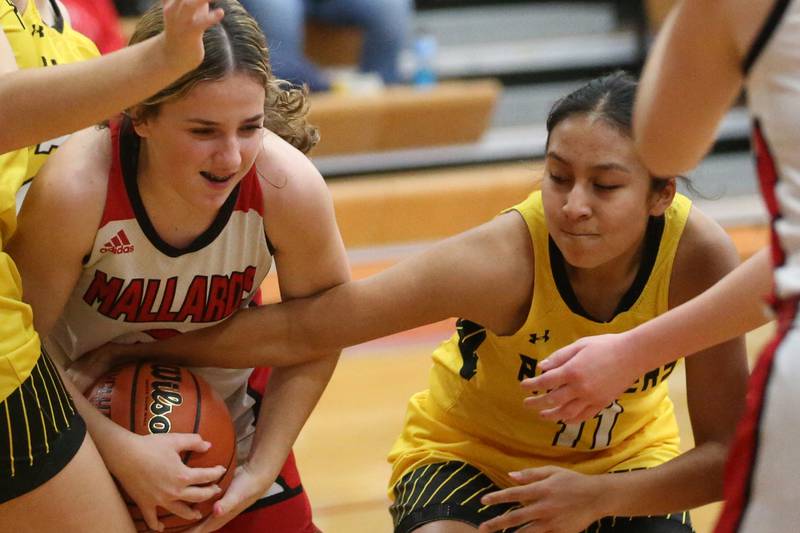 Henry-Senachwine's Lauren Harbison secures the ball while Putnam County's Valeria Villagomez tries to knock it free on Monday, Dec. 18, 2023 in Henry.