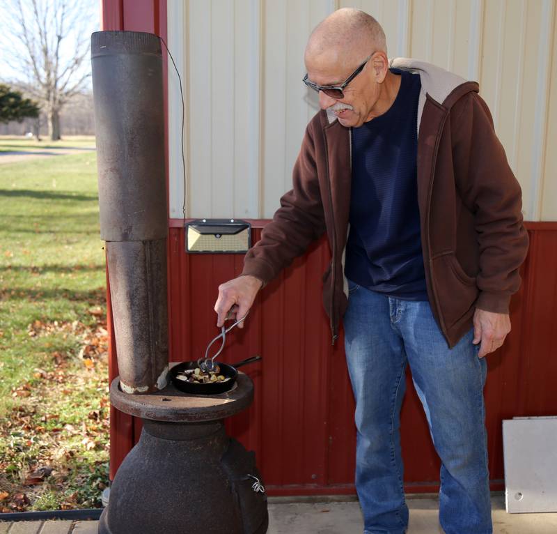 Bruce Hohmann roasts chestnuts at the Kendall County Historical Society’s Annual Christmas at the Lyon Farm on Sunday, Dec. 8, 2024 in Yorkville.