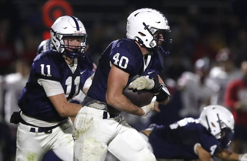 Cary-Grove's Logan Abrams runs with the football during an IHSA Class 5A quarterfinal playoff football game against Belvidere North on Friday, November 14, 2025, at Cary-Grove High School, in Cary.
