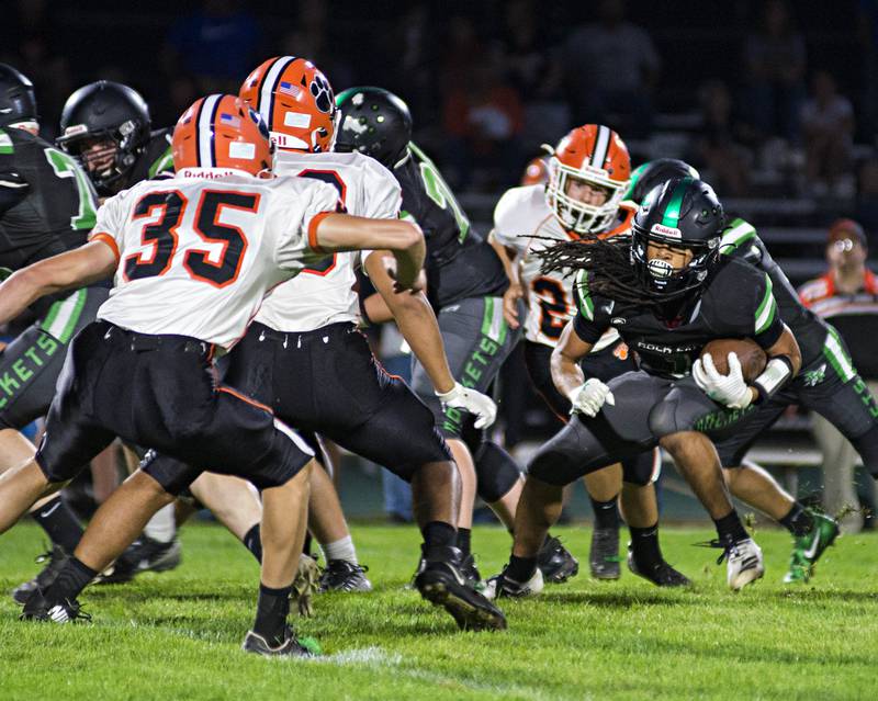 Rock Falls' Booker Cross looks for running room Friday, Oct. 1, 2021.