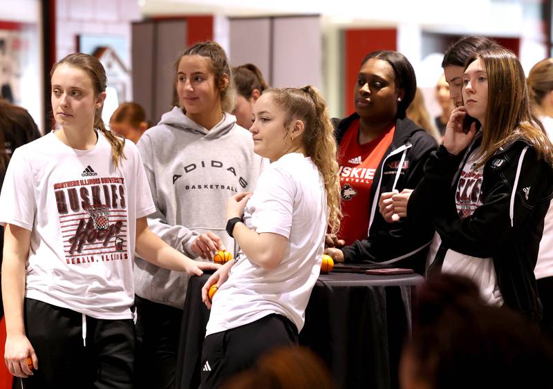Some Northern Illinois University student-athletes listen to speakers during a press conference Thursday, Feb. 27, 2025, at the Convocation Center announcing that NIU will be joining the Horizon League starting with the fall 2026 season for most sports other than football.