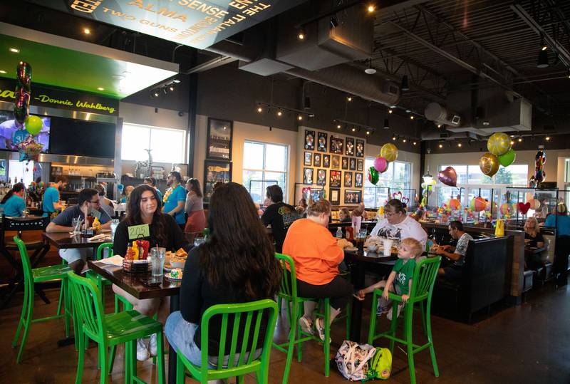 Guests enjoy lunch during the third anniversary of Wahlburgers in St. Charles on July 29, 2023.