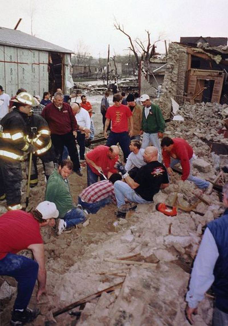 Rescuers remove stone and other materials to try to free victims pinned underneath the Milestone Tap on Tuesday, April 20, 2004 in Utica.